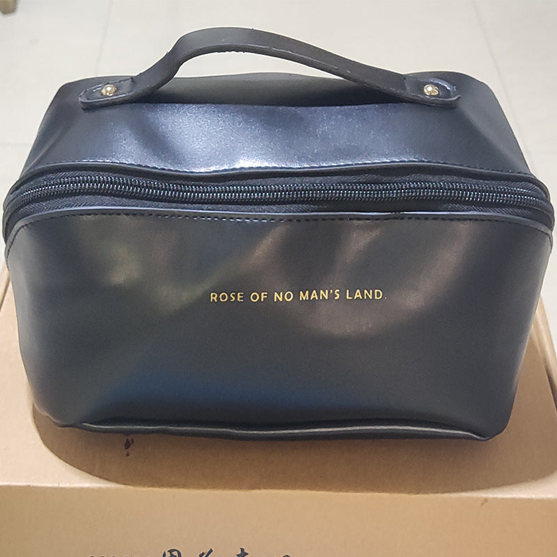 Blue leather bag with 'Rose of No Man's Land' branding on a cardboard surface.