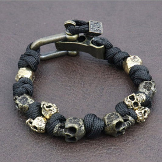 Bracelet with skull beads and metal clasp on a dark background