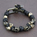 Bracelet with skull beads and metal clasp on a dark background