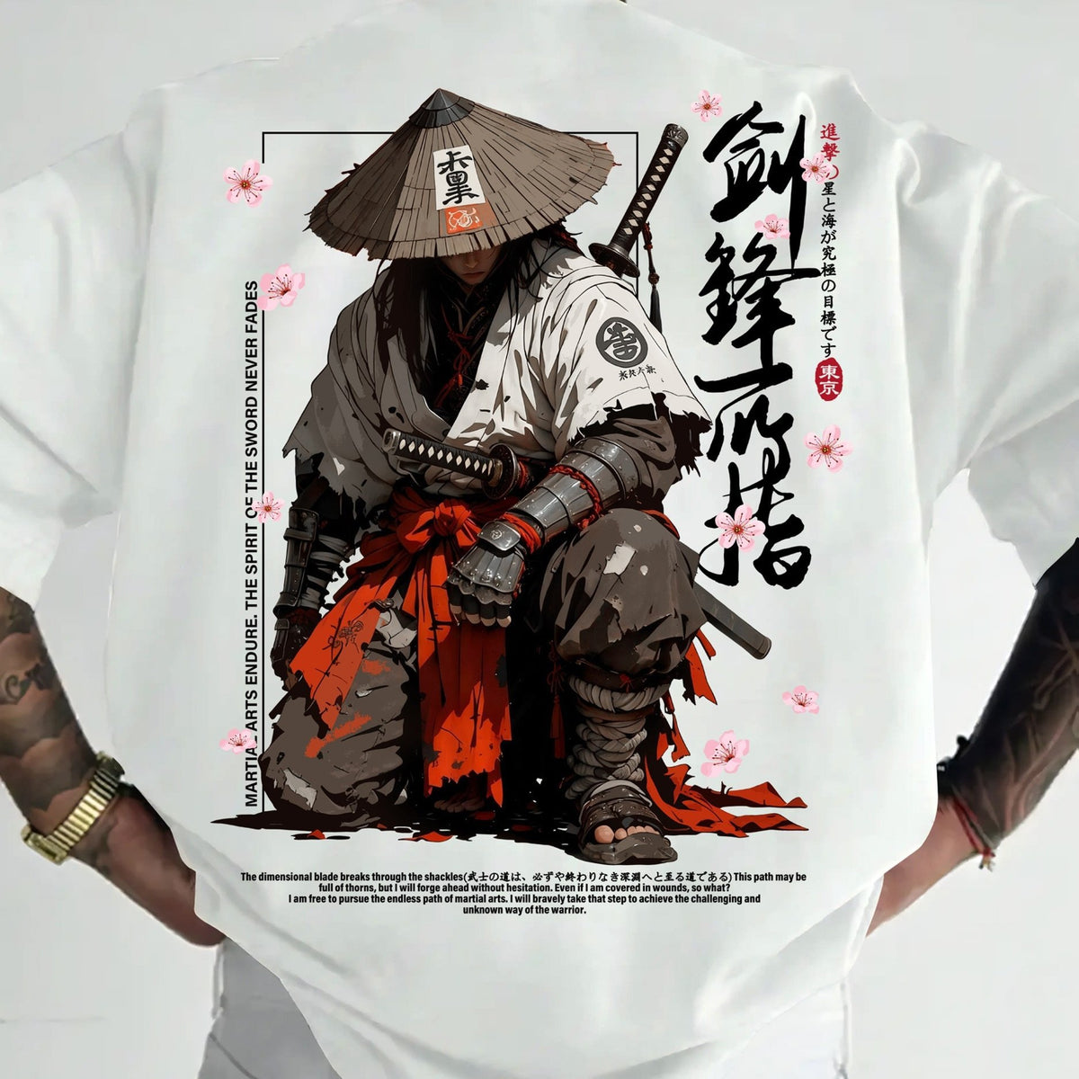 A white short-sleeve t-shirt featuring a large graphic print of a samurai warrior in a conical hat with cherry blossom accents and Japanese calligraphy, shown on a model.