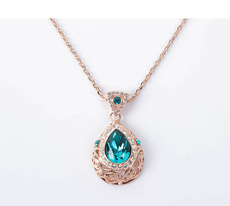 Necklace with a teardrop-shaped green gemstone pendant on a white background