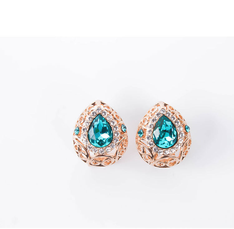 Pair of earrings with turquoise gemstones on a white background