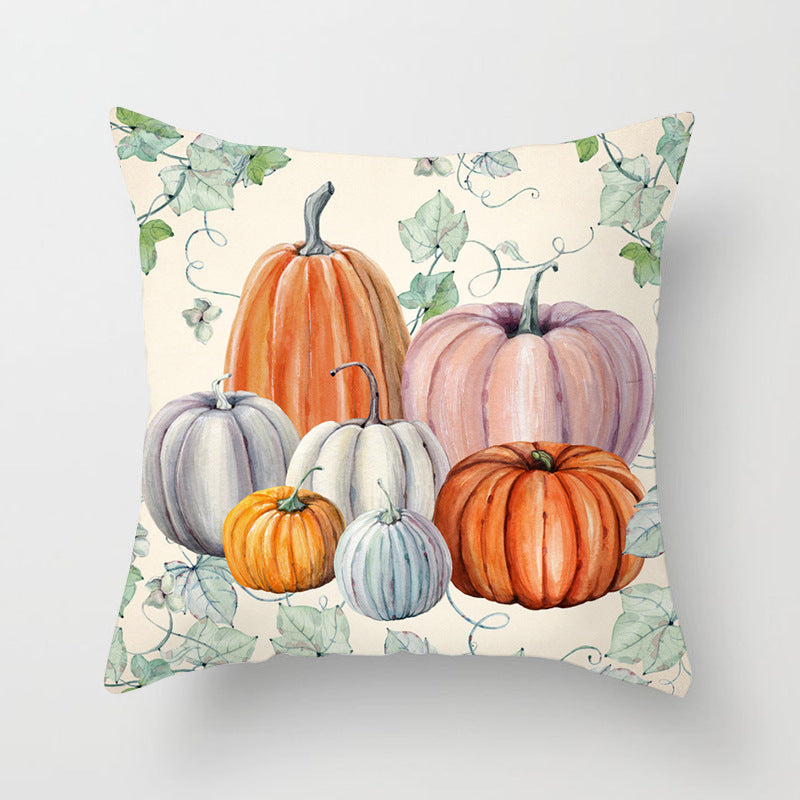 Decorative pillow with pumpkins and leaves on a light background