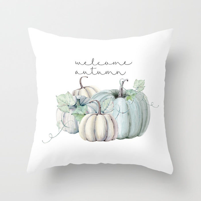 Decorative pillow with pumpkins and 'welcome autumn' text on a white background