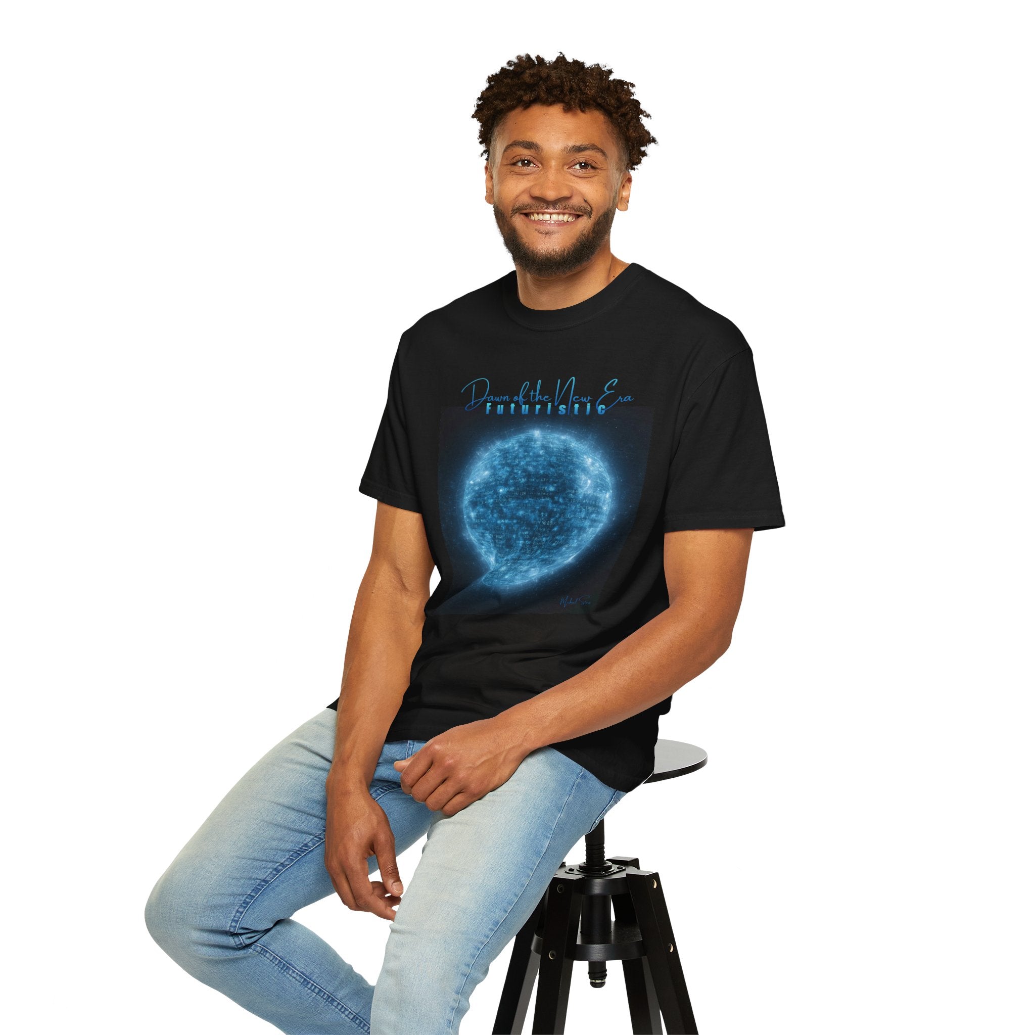 Man wearing a black t-shirt with 'Dog Dad' graphic sitting on a stool against a white background