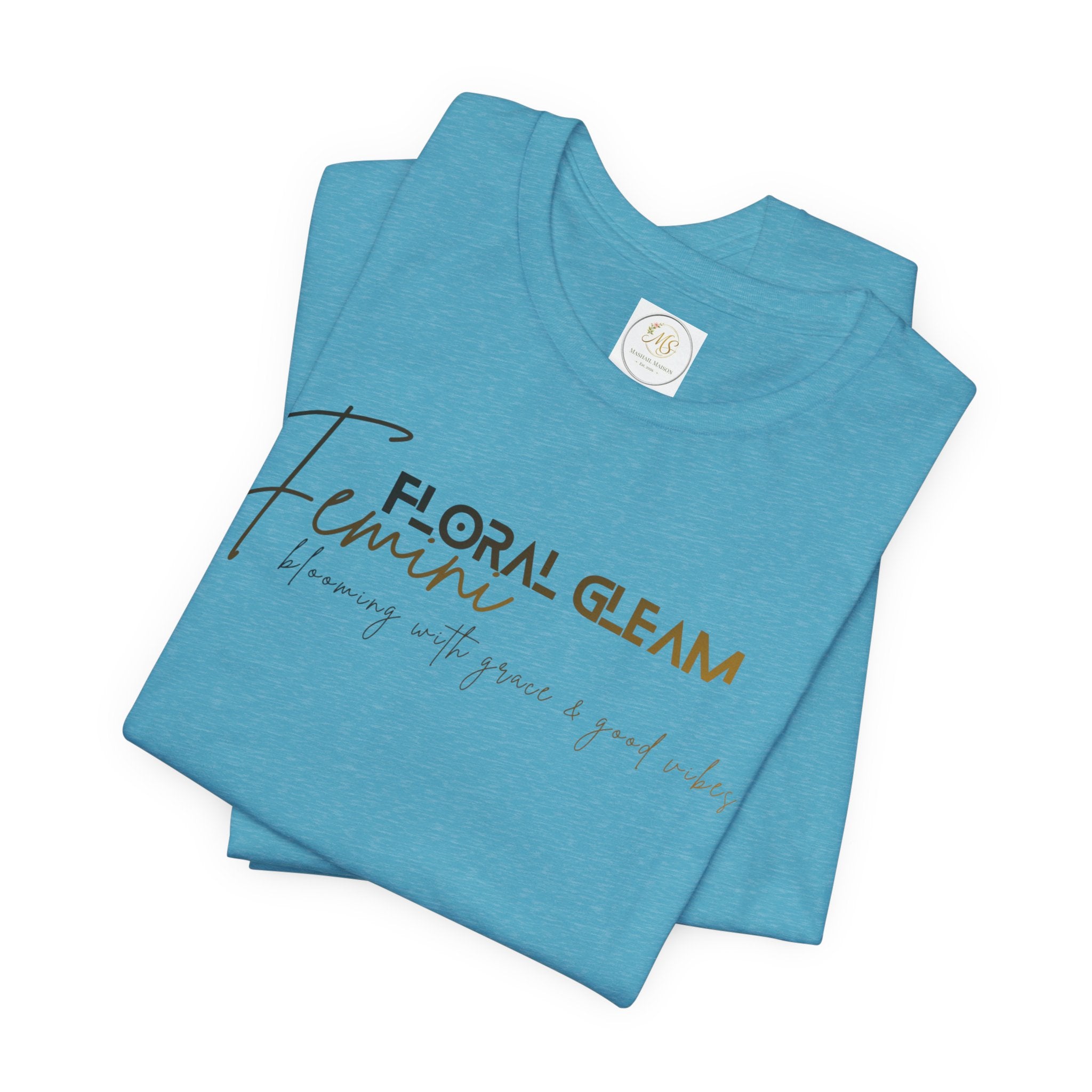 Folded blue t-shirt with 'Floral Gleam' text on a white background