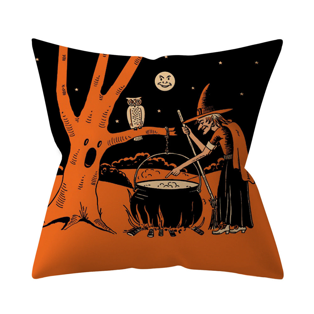 Halloween-themed pillow with a witch, tree, and owl design on an orange and black background.