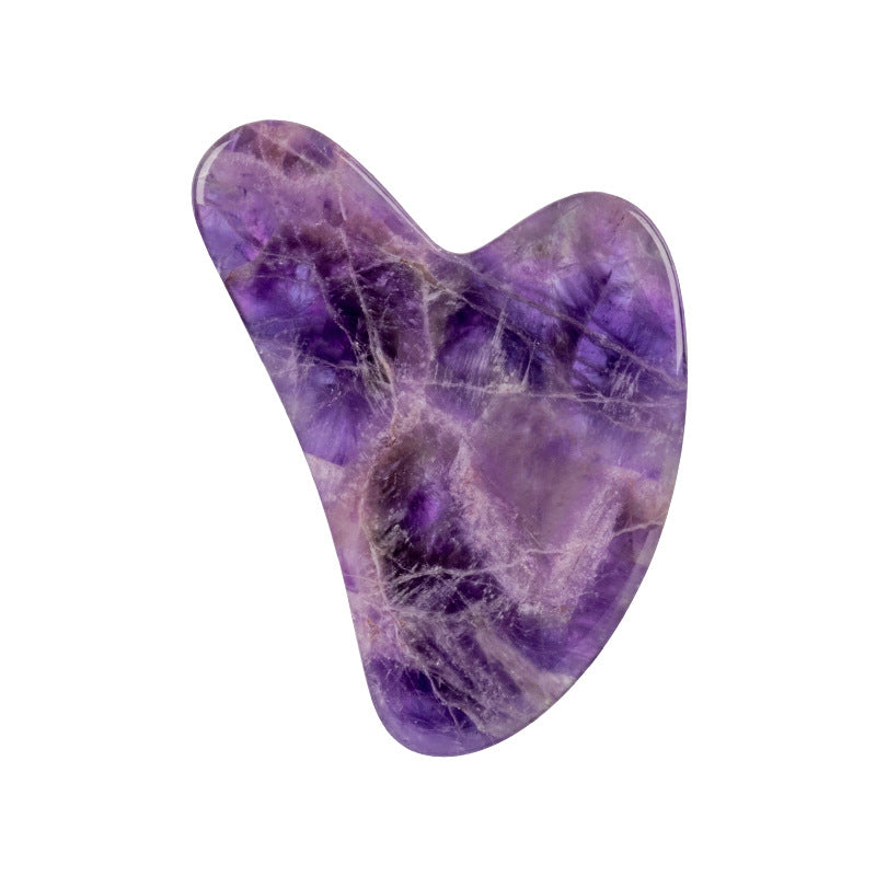 Purple crystal heart-shaped stone on a white background