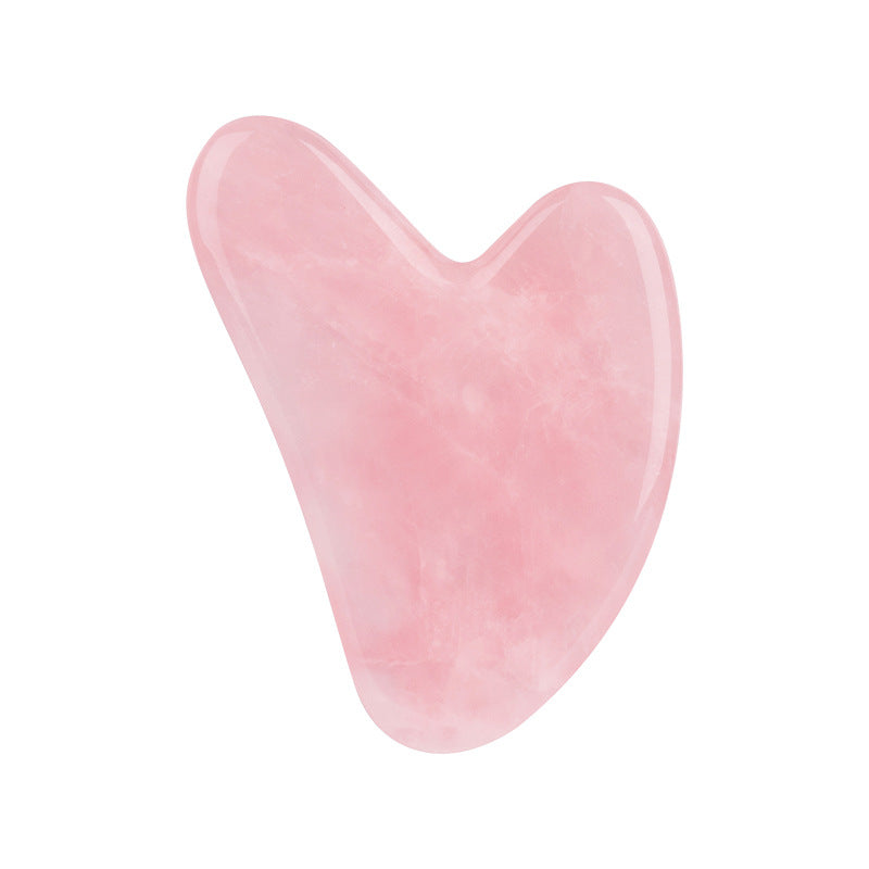 Pink heart-shaped object on a white background