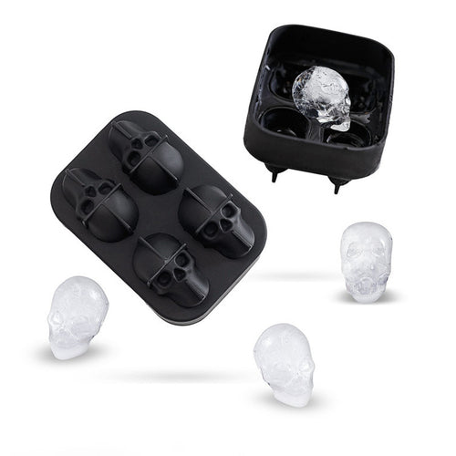 Black skull-shaped ice cube tray with freshly formed ice cubes on a white background