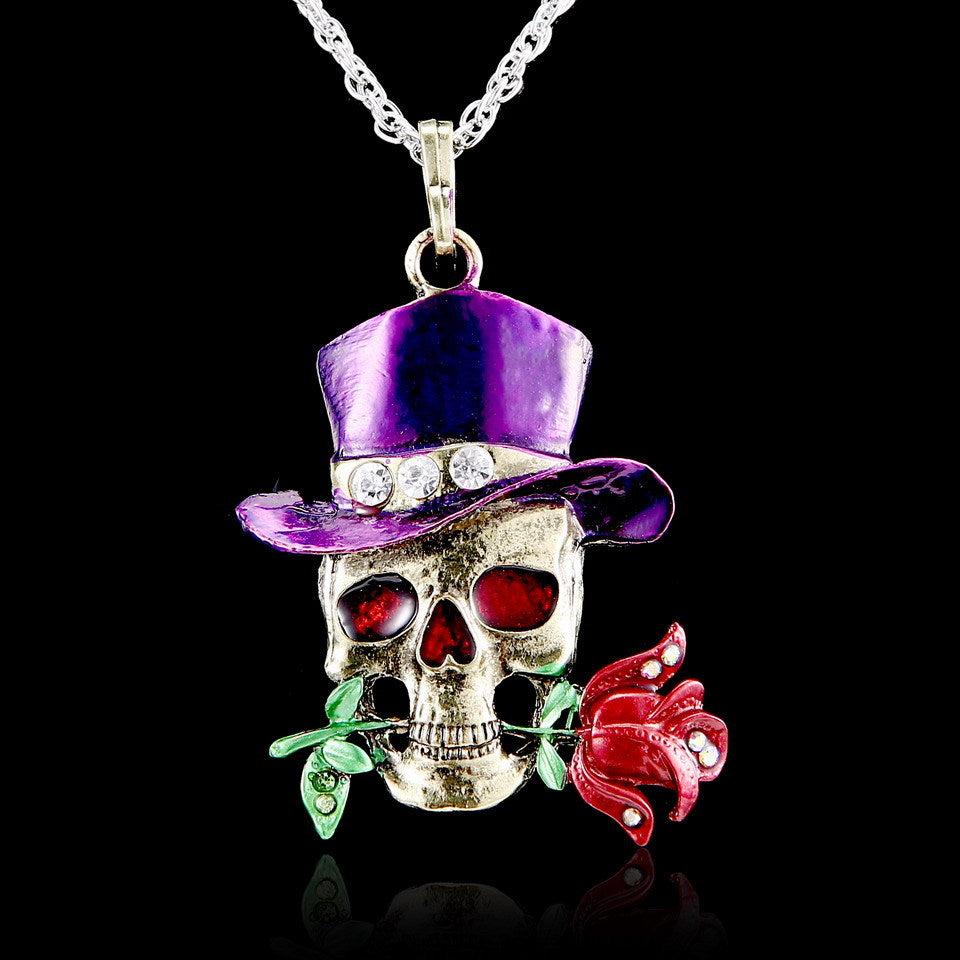 Skull pendant with purple top hat and red rose on a black background