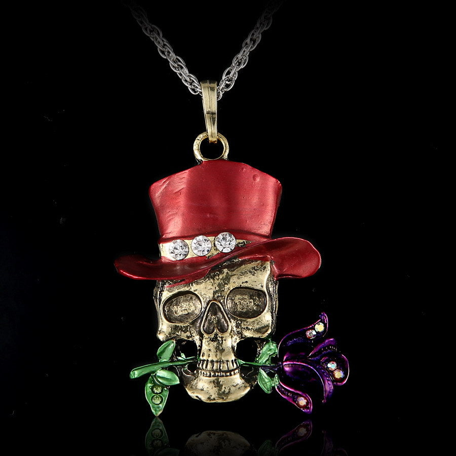 Skull pendant with red top hat and flowers on a black background