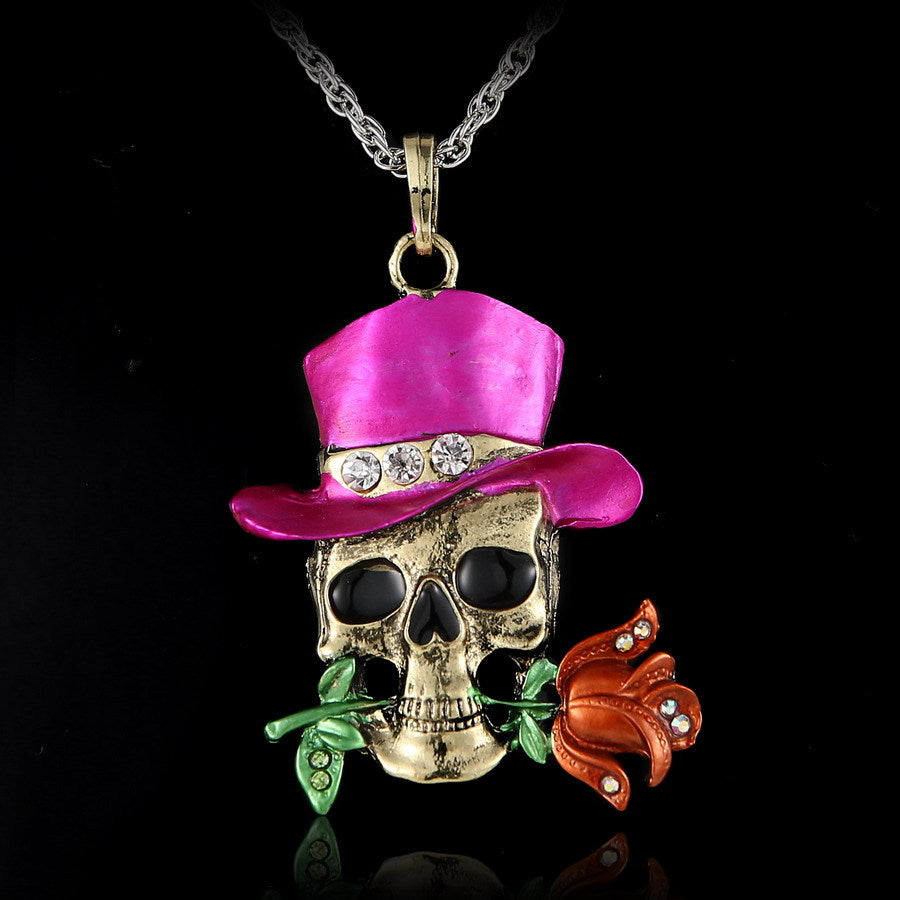 Skull pendant with pink top hat and rose on a black background