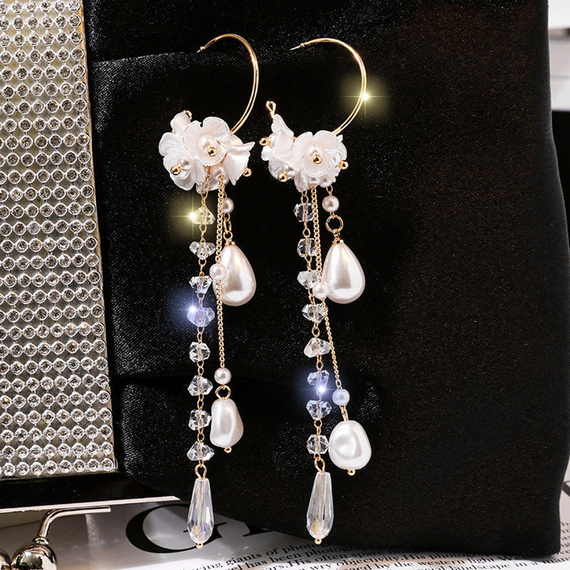 Pearl and crystal earrings on a dark background
