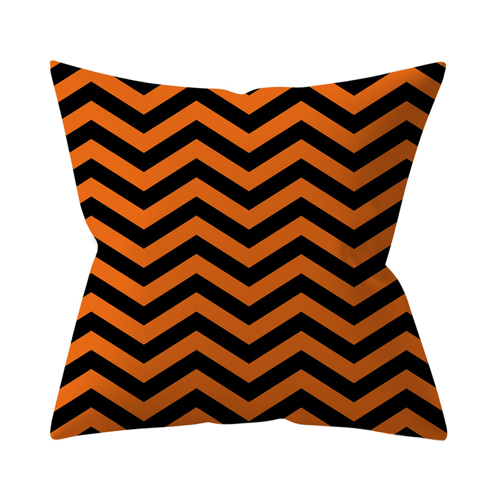 Pillow with black and orange chevron pattern on a white background