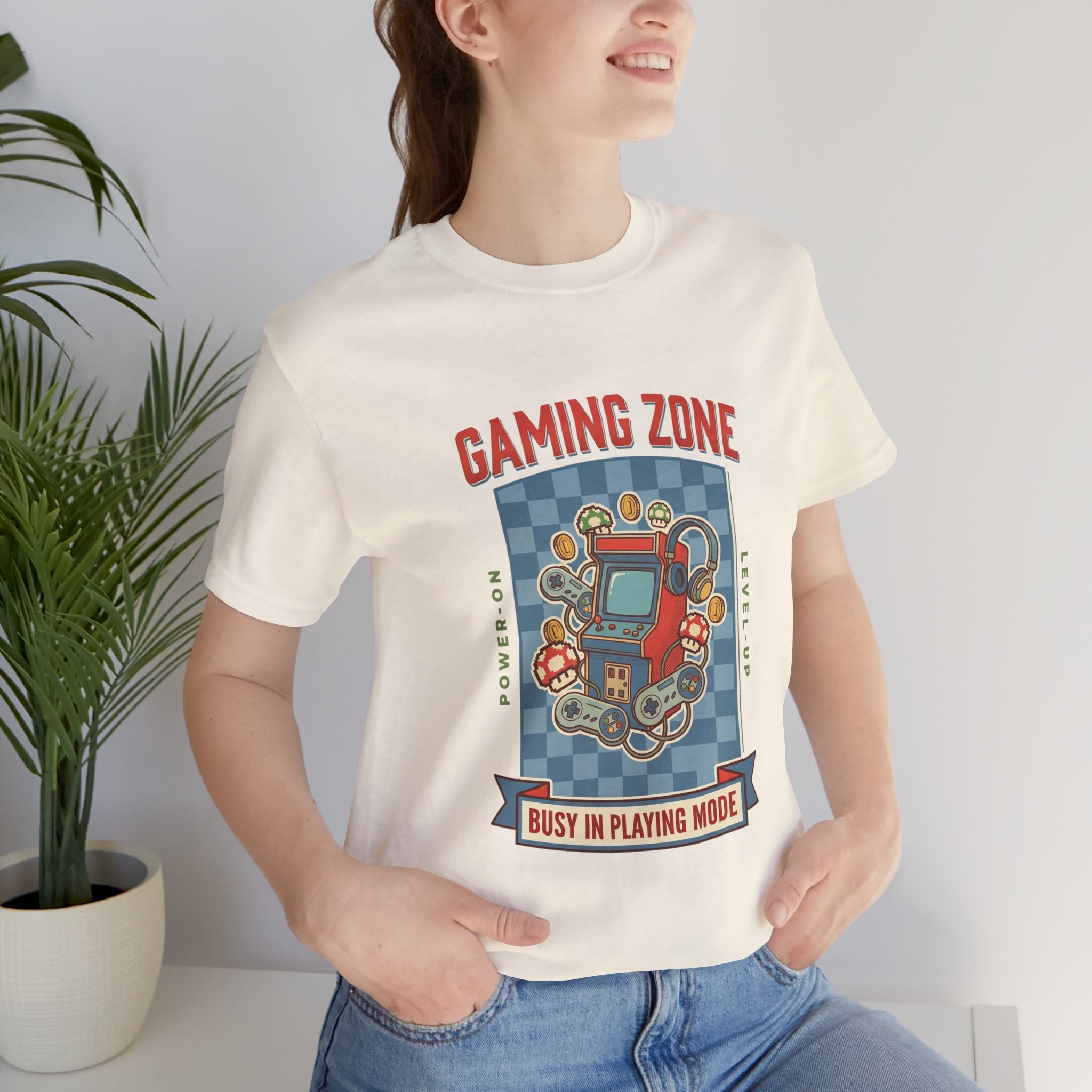 Person wearing a 'Gaming Zone' t-shirt with a retro arcade design.