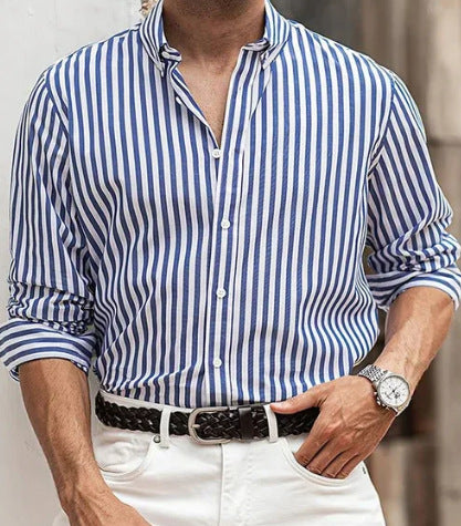 Person wearing a blue and white striped shirt with rolled-up sleeves, white pants, and a watch.