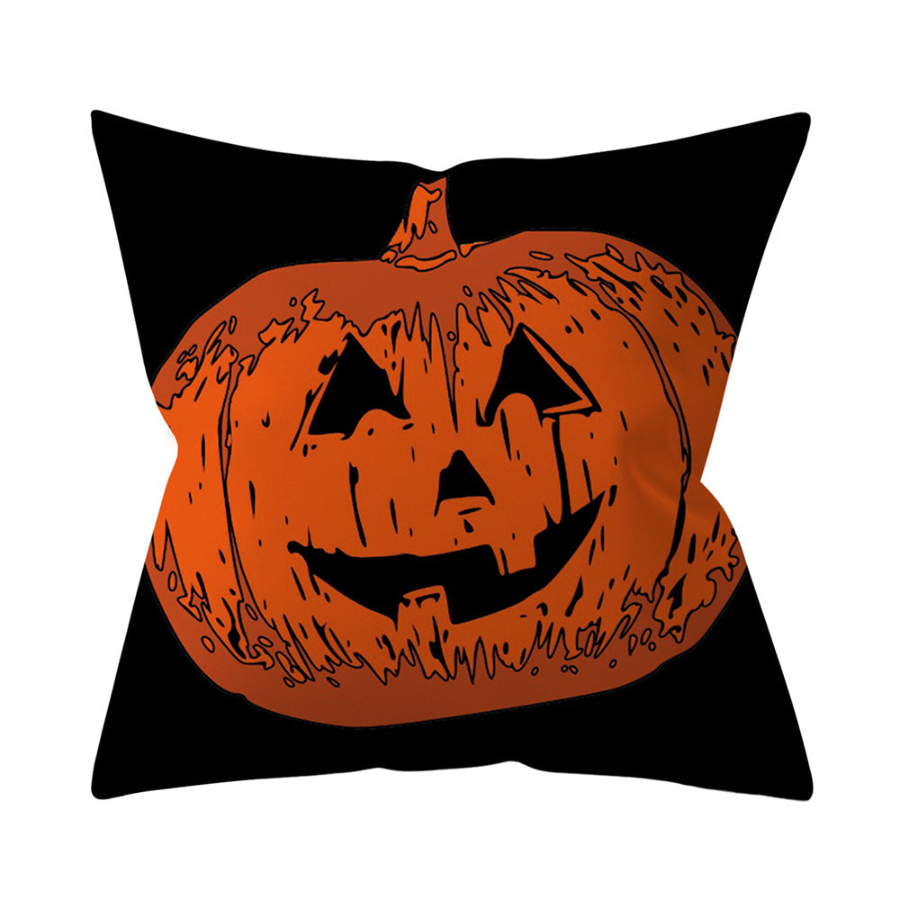 Pillow with a jack-o'-lantern design on a black background