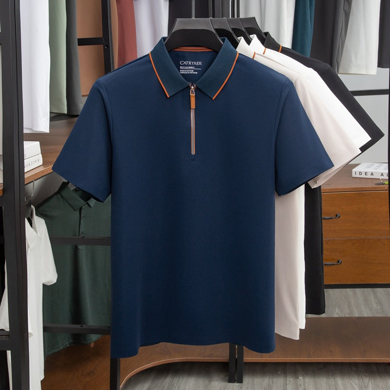 Blue polo shirt with orange accents on a hanger in a clothing store.