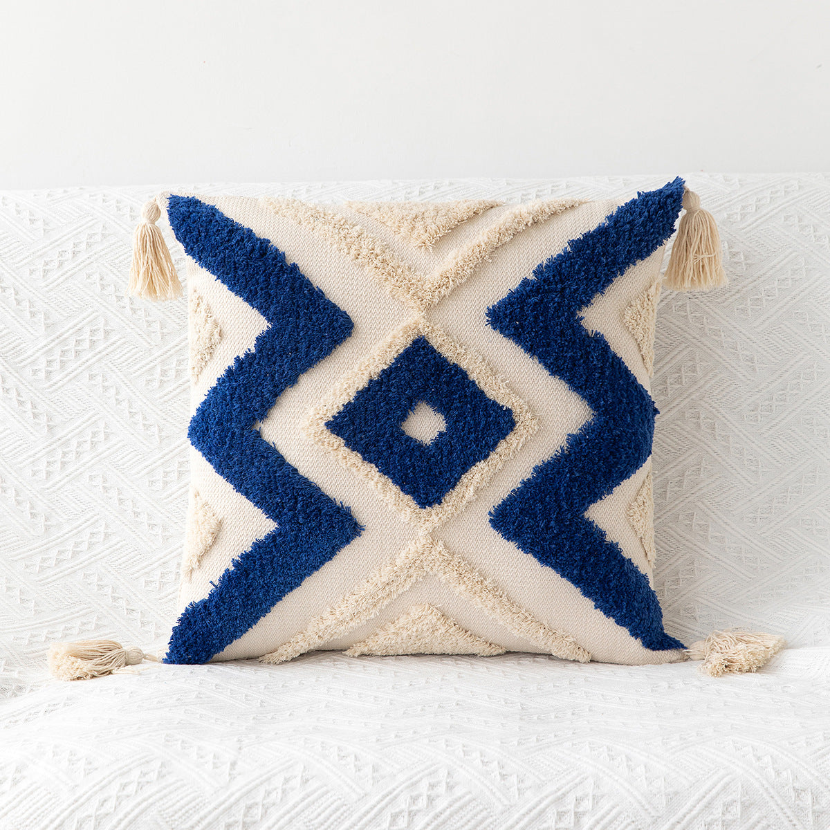 Decorative pillow with blue zigzag pattern on a white background