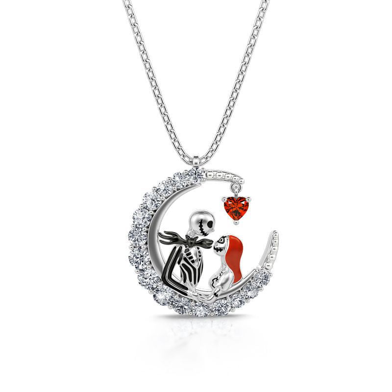 Silver necklace with a moon-shaped pendant featuring a skeleton and a red dress, on a white background.