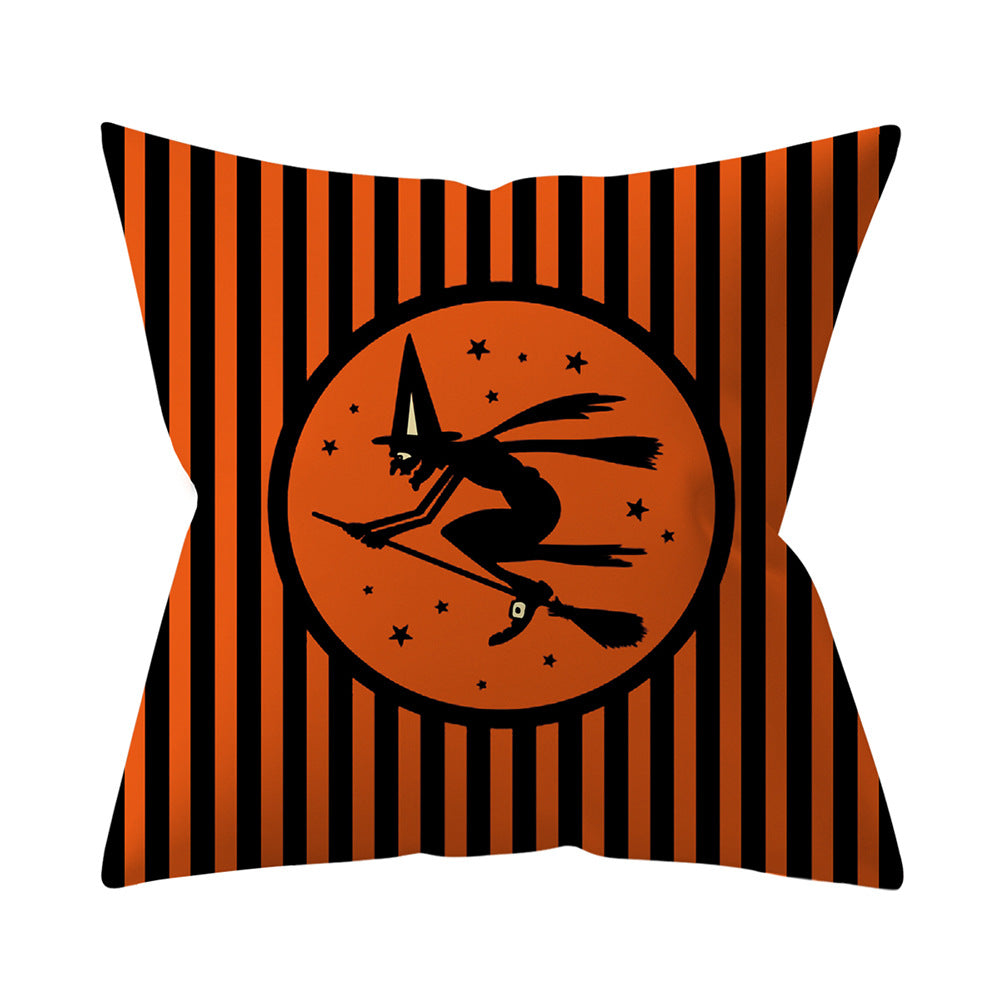 Halloween-themed pillow with witch and broom design on orange and black striped background