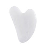 White gua sha tool on a white background