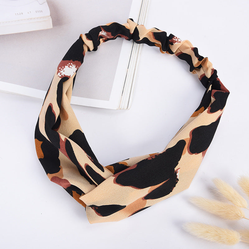 Leopard print headband on a white background