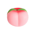 Pink round Peach Squishy with green top on a white background