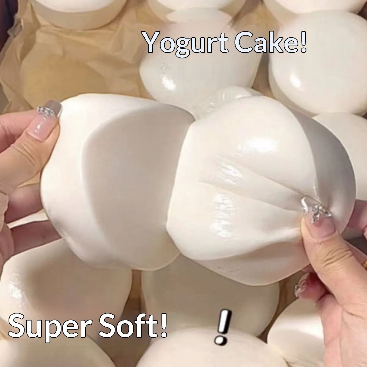 White, soft yogurt squishy being held by hands with text 'Yogurt Cake!' and 'Super Soft!' displayed.