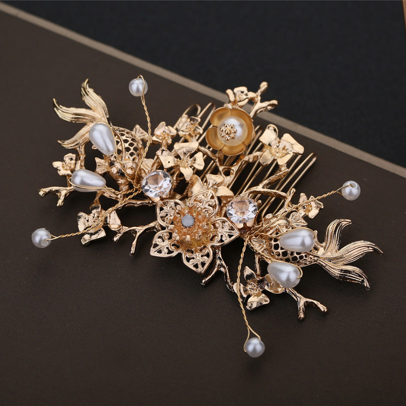 Gold floral brooch with pearls on a dark background