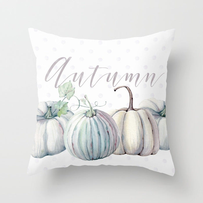 Decorative pillow with pastel pumpkins and the word 'Autumn' on a light background