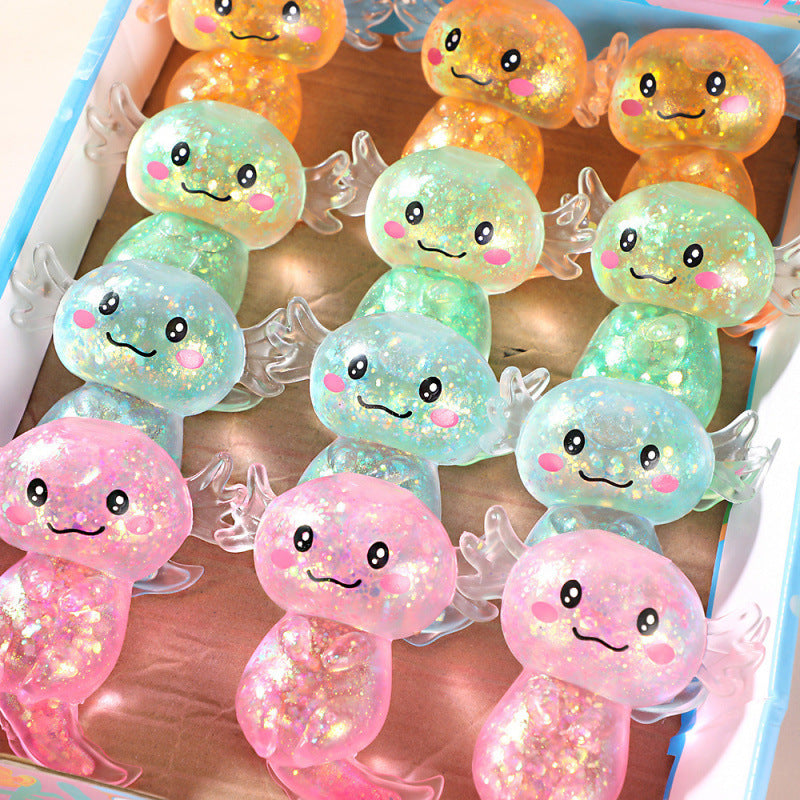 Colorful plush squishy toy with smiling faces on a wooden surface.
