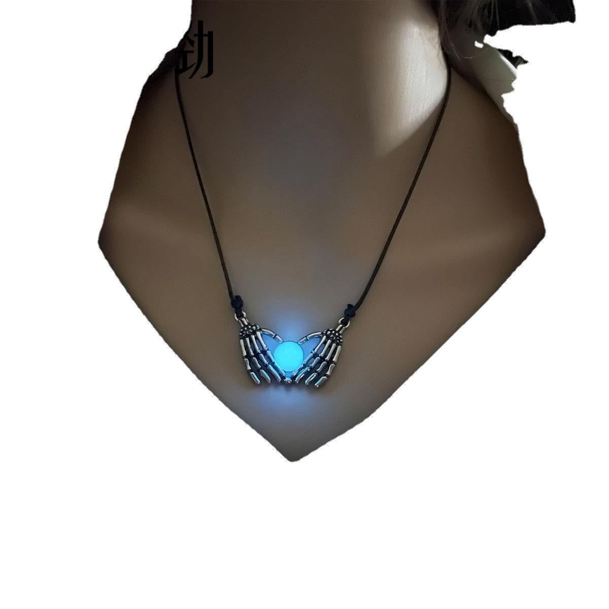 Necklace with a glowing blue pendant on a mannequin neck.