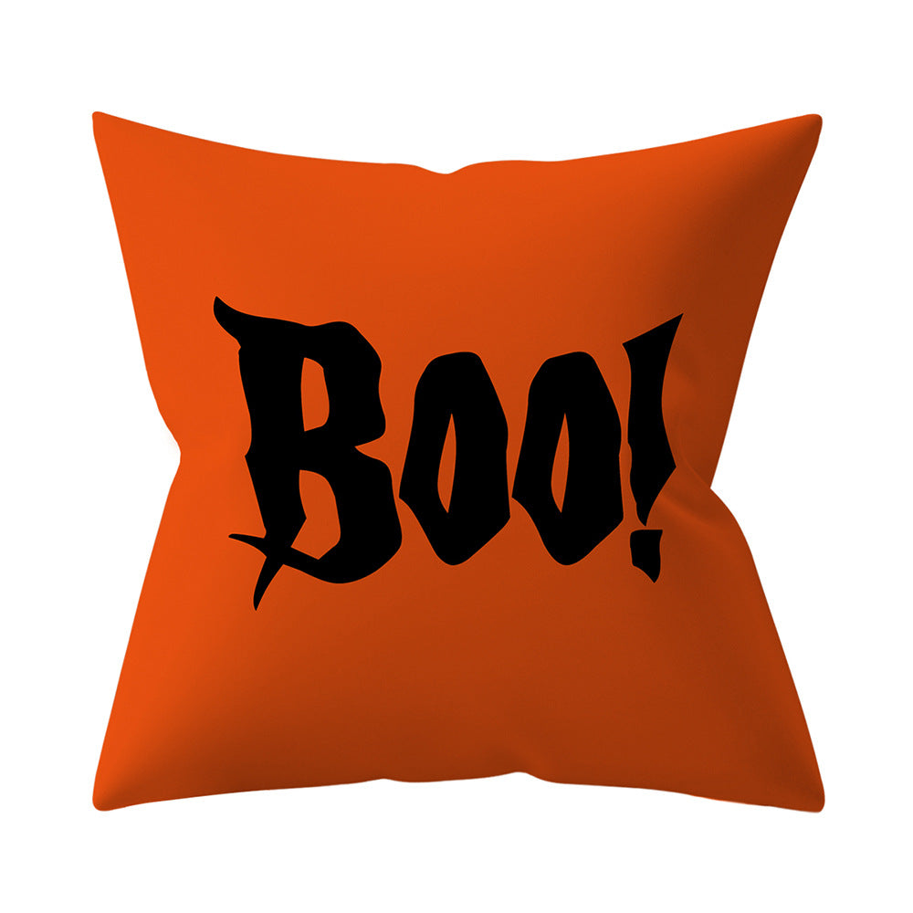 Orange pillow with black 'Boo!' text on a white background