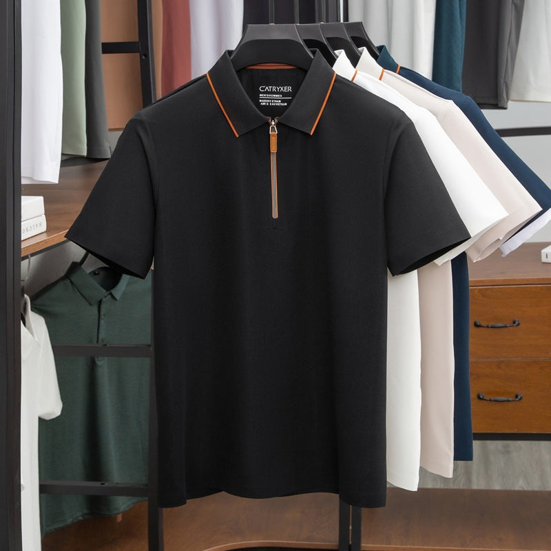 Black polo shirt with orange trim on a rack with other shirts in a store setting