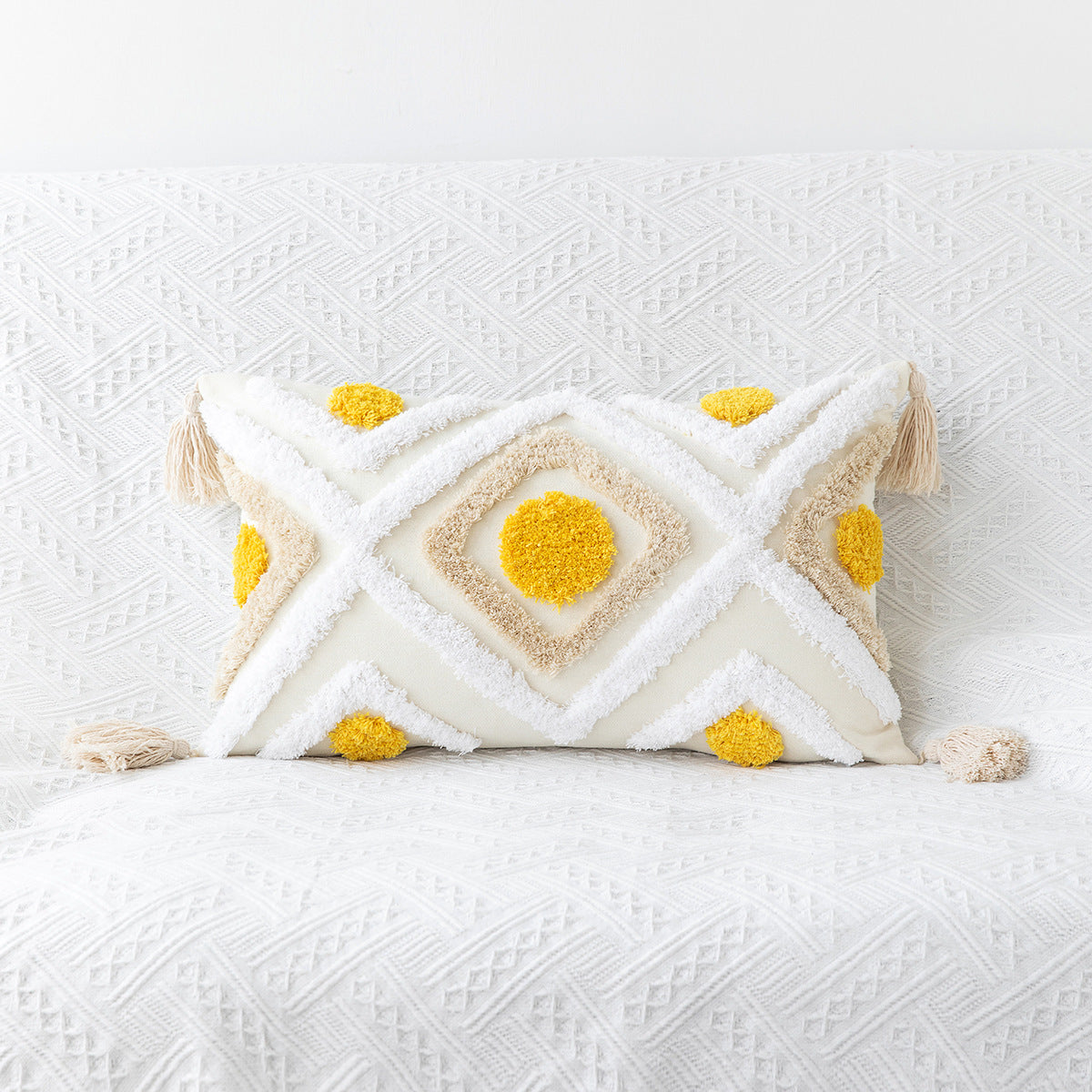 Decorative pillow with geometric pattern and yellow accents on a white textured surface