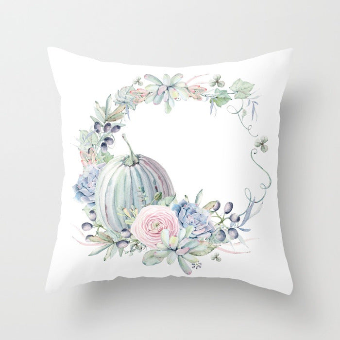 Decorative pillow with floral and cactus design on a white background
