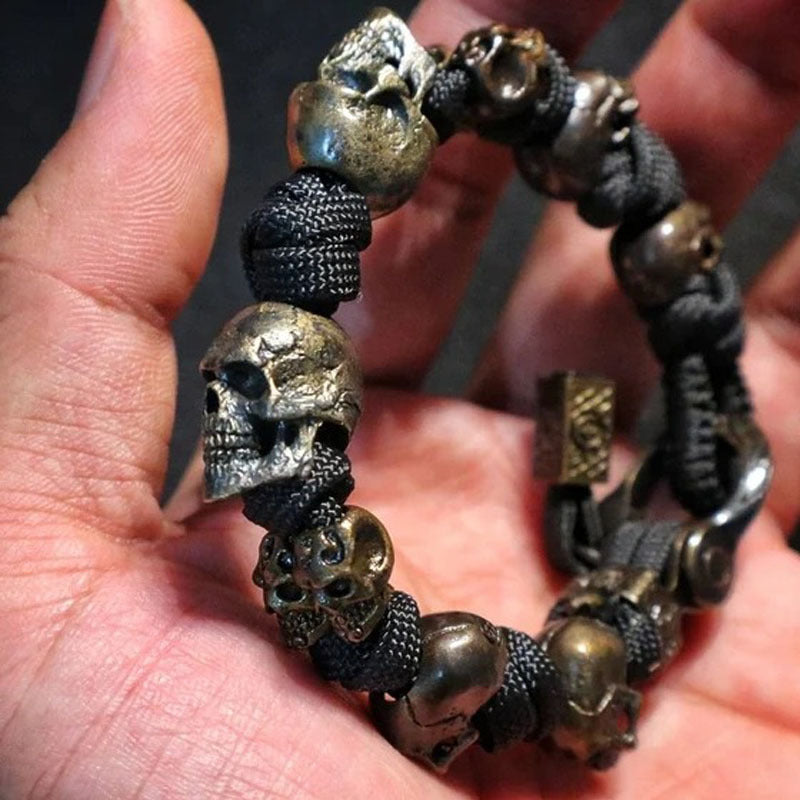 Bracelet with skull-shaped beads held in a hand