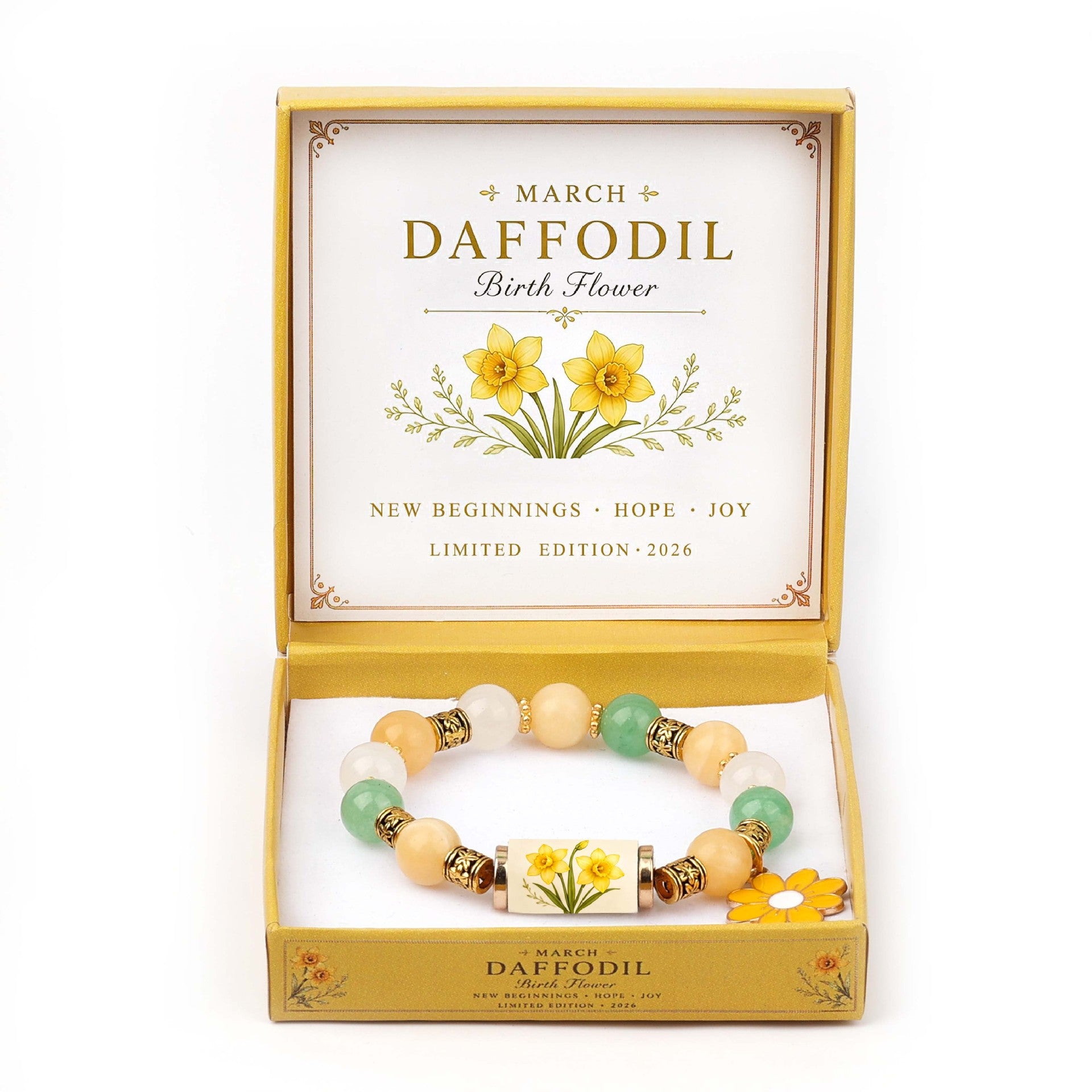 A beaded bracelet presented in an open gold-toned gift box labeled 'March Daffodil Birth Flower.' The bracelet has pastel peach, cream, mint green, and white beads with small metallic spacer rings and a central daffodil motif.