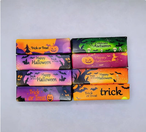 Eight Halloween-themed butter squishy bars in colorful designs arranged in a 2x4 grid on a light gray background. The designs on bar feature festive designs with pumpkins, bats, ghosts, and seasonal text like 'Happy Halloween' and 'Trick or Treat'.