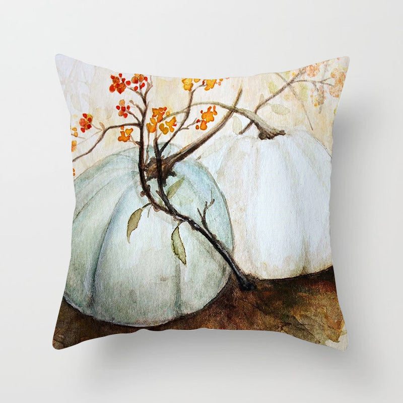 Decorative pillow with pumpkins and autumn leaves design on a white background