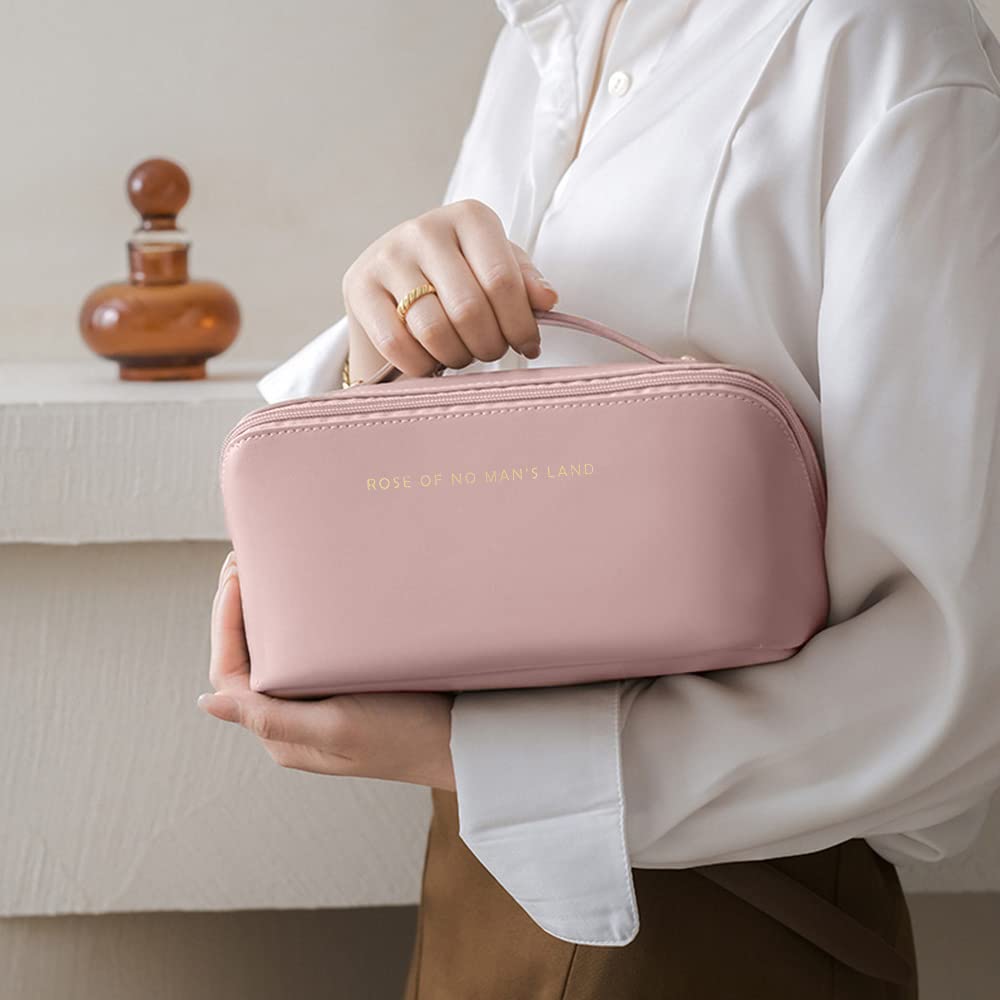 Person holding a pink travel bag with 'Roll of Honour' branding.