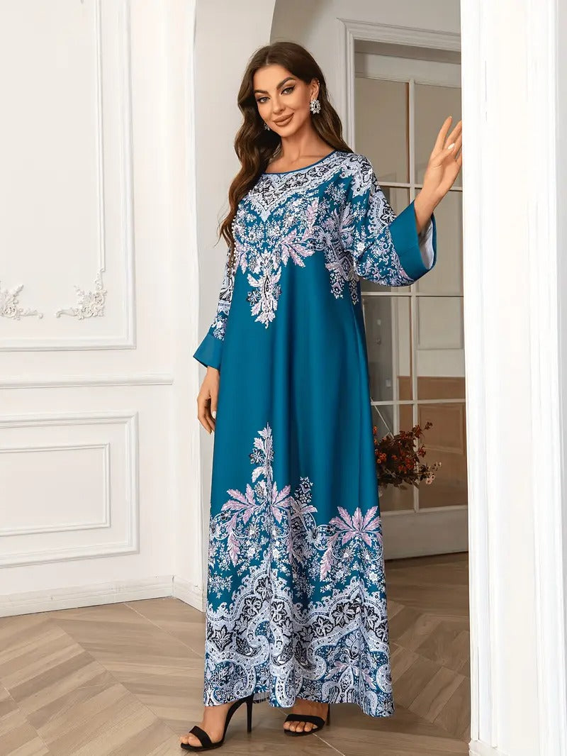 Woman wearing a blue and white floral dress in an indoor setting