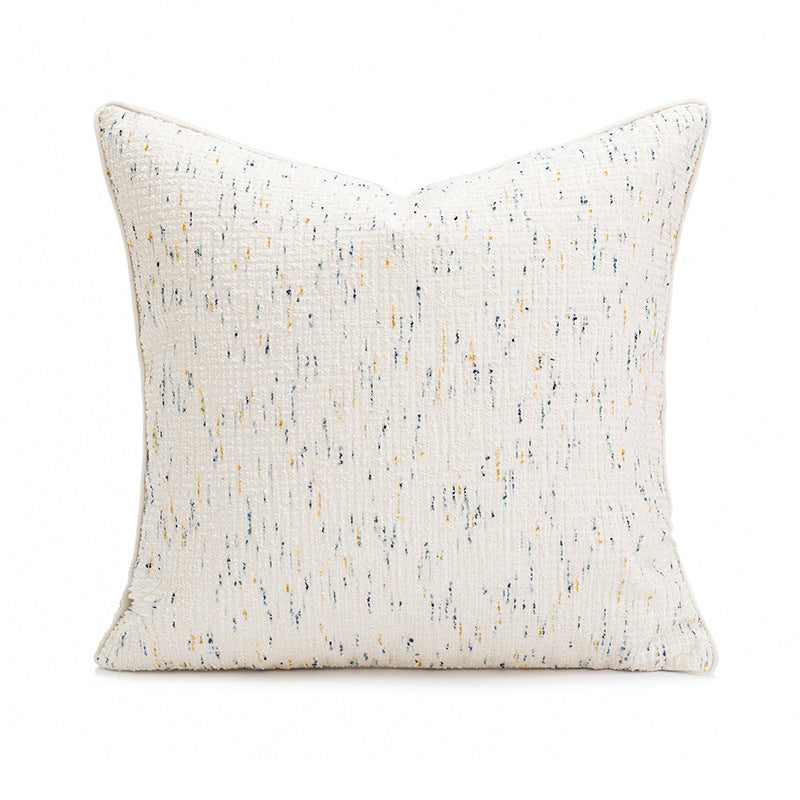 A square decorative throw pillow with a textured, off-white woven fabric featuring a subtle vertical speckled pattern in navy blue and mustard yellow, shown on a plain white background.