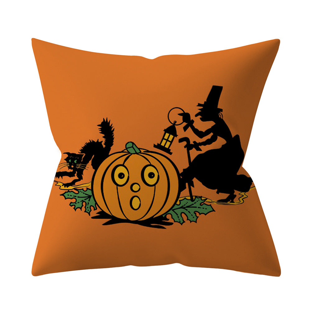 Orange pillow with Halloween-themed design featuring a witch, pumpkin, and cat on an orange background.