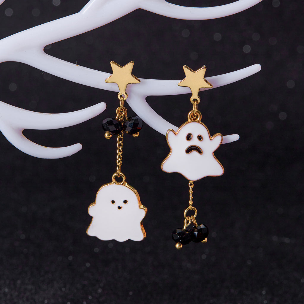 Halloween-themed ghost earrings with gold accents on a dark background
