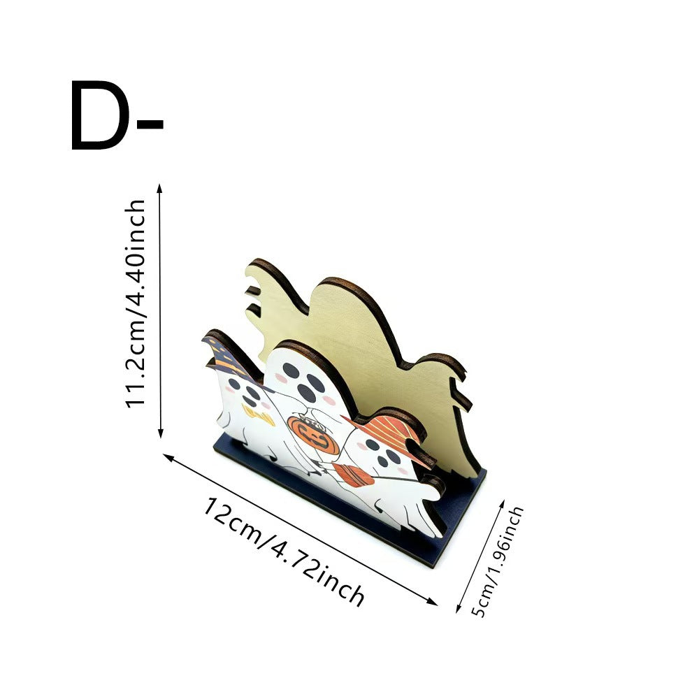 A ghost-shaped tabletop holder with a Halloween design, shown with dimension arrows and labels indicating 11.2 cm height, 12 cm width, and 5 cm depth on a white background.