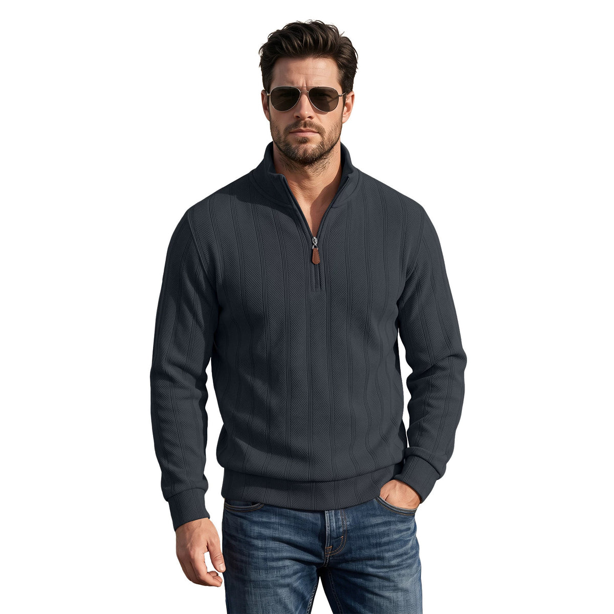 A man wearing a dark charcoal gray ribbed quarter-zip pullover sweater with a small orange zipper pull, paired with blue jeans and sunglasses, against a solid white background.