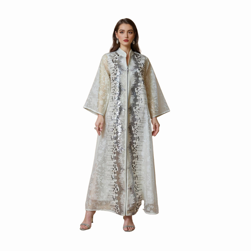 Woman wearing a long, patterned dress on a white background
